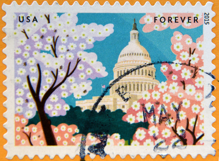 USA - CIRCA 2015: A stamp printed in USA shows The United States Capitol with flowering dogwood and flowering cherry trees, circa 2015のeditorial素材