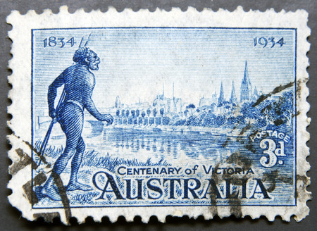 AUSTRALIA - CIRCA 1934: Stamp printed in Australia shows the Yarra Yarra Tribesman, Yarra River and View of Melbourne, Centenary of Victoria, circa 1934の写真素材
