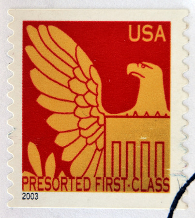 GRANADA, SPAIN - APRIL 14, 2014: stamp printed in USA shows head right wing of red bald eagle with shield on breast, 2011のeditorial素材