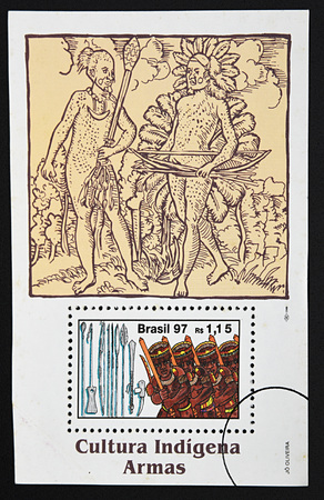 GRANADA, SPAIN - DECEMBER 16, 2015: A stamp printed in Brazil dedicated to indigenous culture, weapons, 1997のeditorial素材