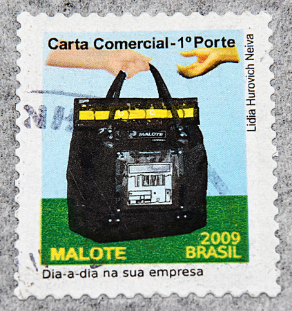 GRANADA, SPAIN - NOVEMBER 30, 2015: A stamp printed in Brazil shows two hands passing bag, 2009のeditorial素材