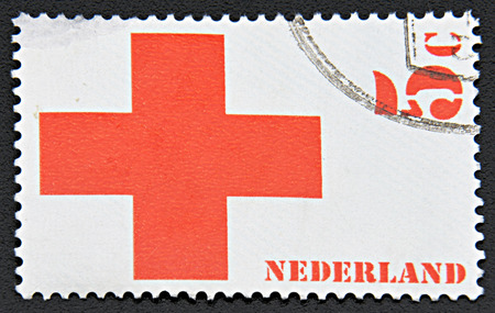 GRANADA, SPAIN - NOVEMBER 30, 2015: A stamp printed in Netherlands shows Red Crossのeditorial素材