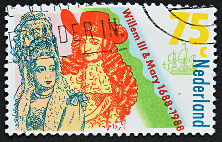 GRANADA, SPAIN - NOVEMBER 30, 2015: A stamp printed in Netherlands shows Coronation of William III and Mary Stuart, King and Queen of England, 1988のeditorial素材