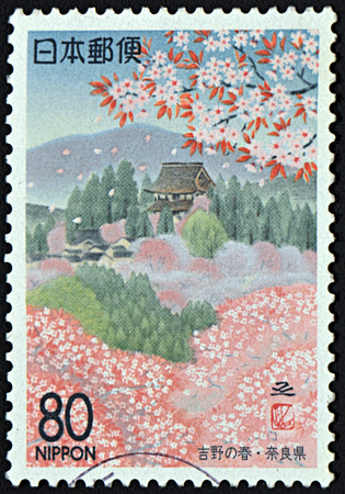 GRANADA, SPAIN - NOVEMBER 30, 2015: A stamp printed in Japan shows beautiful view on Sakura flowers outdoors, circa 1990のeditorial素材
