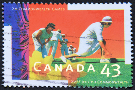 GRANADA, SPAIN- NOVEMBER 30, 2015: A stamp printed in Canada shows XV Commonwealth Games, Victoria, Lawn bowls, 1994のeditorial素材