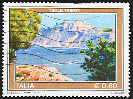 GRANADA, SPAIN - NOVEMBER 30, 2015: A stamp printed in Rome shows beautiful view on fortress on mountain near the ocean, islands tremors, 2010のeditorial素材
