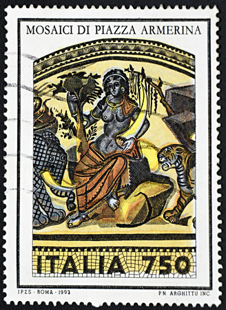GRANADA, SPAIN - NOVEMBER 30, 2015: A stamp printed in Rome shows priestess surrounded by tiger and elephant, mosaics of Piazza Armerina, 1993のeditorial素材