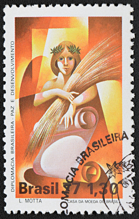 GRANADA, SPAIN - NOVEMBER 30, 2015: a stamp printed in Brazil shows Woman Holding Sheaf, 1977のeditorial素材