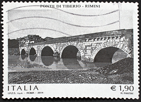 GRANADA, SPAIN - NOVEMBER 30, 2015: A stamp printed in Rome shows Tiberius Bridge in Rimini, 2014のeditorial素材