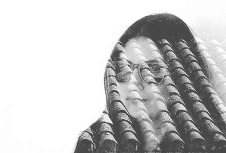 Woman and old roof tiles. Double exposure taken with camera.の写真素材