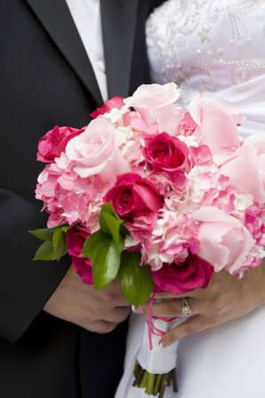 Bride and Groom Holding a Bouquet on Their Wedding Dayの写真素材