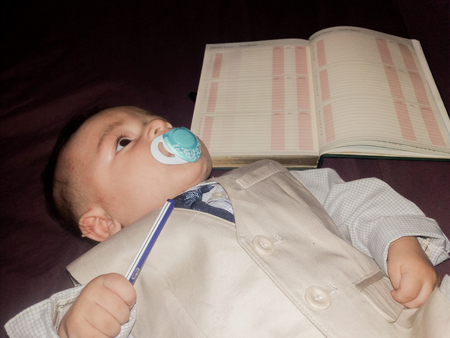 baby teacher sirious bossy baby in the suit with neck tieの写真素材