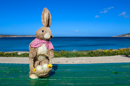 female easter bunny holding basket with eggsの写真素材