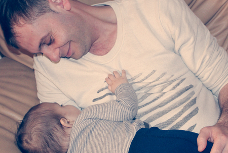 Father holding six month old baby boy