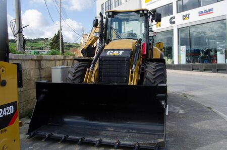 Burmarrad, Malta, 15 december 2018 - small lifter Excavator in the machinery store