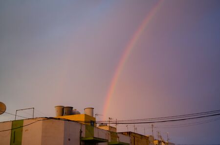 Qawra, Malta 30. may 2019 - rainbow over the residential buildingsのeditorial素材