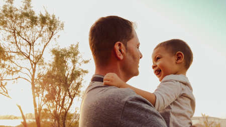 Young caucasian father holding his son toddler. Baby touching the face of his dad. High quality photoの写真素材