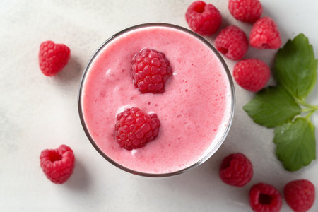 A glass of raspberry smoothie refreshing and healthy breakfast. High quality photoの素材