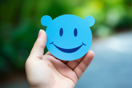 promoting positive mental health hand holding paper smiley. High quality photoの素材