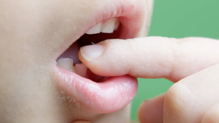 Close up on childs milk teeth. Boy wigling his tooth . High quality photoの写真素材