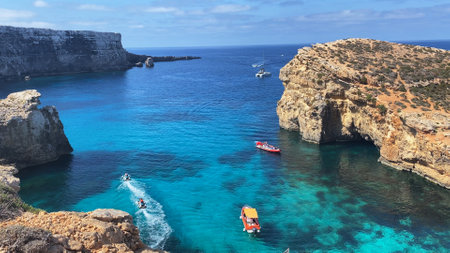 Luxury vacation. Visiting Comino caves in a boat. Malta, Mediterranean sea. High quality photo