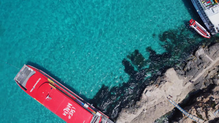 Comino, Malta - 29.05.2024 - Moored Boats and yacht on the pier of Comino islan near Blue lagoon. Aerial view. High quality photoのeditorial素材