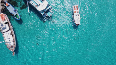 Comino, Malta - 29.05.2024 - Moored Boats and yacht on the pier of Comino islan near Blue lagoon. Aerial view. High quality photoのeditorial素材