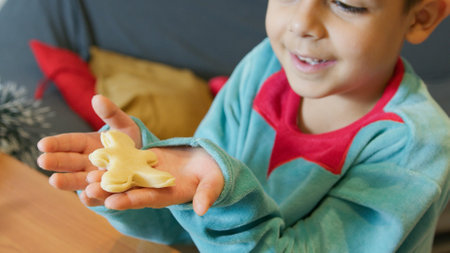 Cute boy making christmas gingerbread cookies. High quality photo