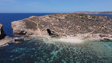 Comino, Malta 29.05.2024 - Beautiful white sand beach on Uninhabited Cominotto island, and Blue...