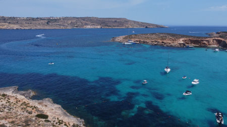 Comino, Malta 29.05.2024 -Beautiful white sand beach on Uninhabited Cominotto island, and Blue...