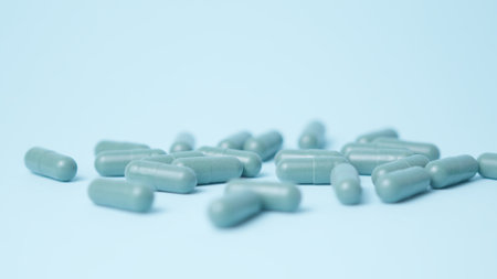 Hand grabbing bunch of green capsules. Green pills. High quality photo