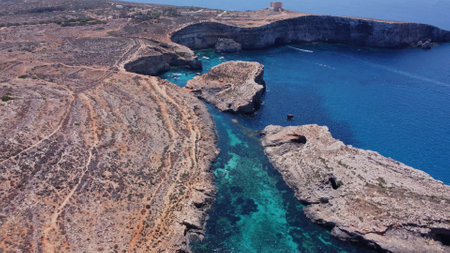 Natural windows in the rocks, Comino Island Malta, Close up revealing drone shot. High quality photoの写真素材