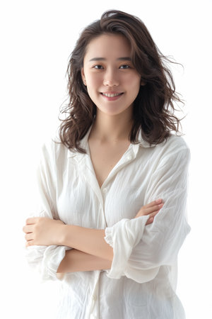 Portrait of a happy young Asian woman dressed in white. High quality photoの素材