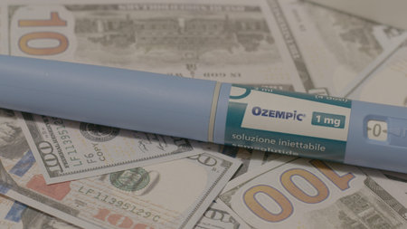 07.October 2025 - Qawra, Malta - Ozempic Injection Pen Lying on Banknotes Editorial. High quality...