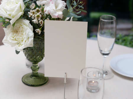 Mockup white blank space card, for greeting, table number, wedding invitation template on wedding table setting background.の写真素材