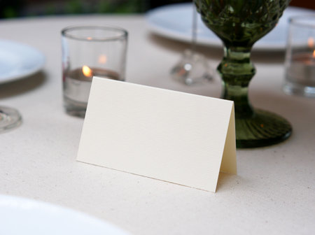 Mockup white blank space card, for Name place, Folded, greeting, invitation on wedding table setting background.の写真素材
