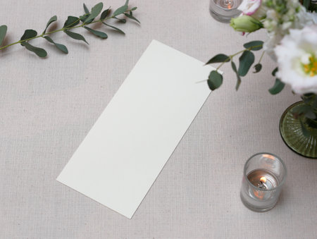Mockup white blank space card, for Menu, Flyer, greeting, invitation on wedding table setting backgroundの写真素材
