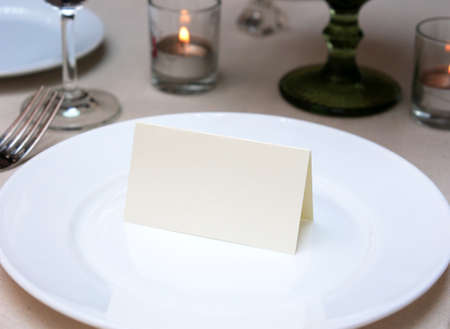 Mockup white blank space card, for Name place, Folded, greeting, invitation on wedding table setting background.の写真素材