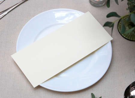 Mockup white blank space card, for Menu, Flyer, greeting, invitation on wedding table setting background.の写真素材