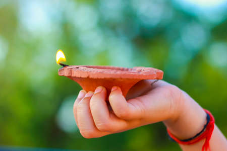 Indian Festival Diwali, lamp in handの写真素材