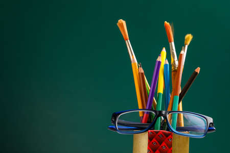 The concept of the teacher's day, School stationery, pencil, pen, note, Spectacles in pen box