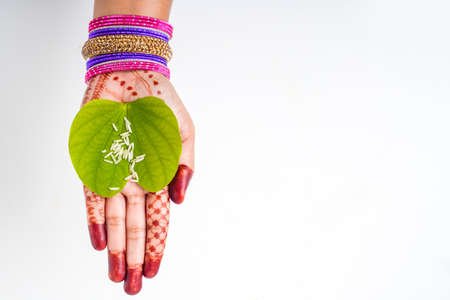 Indian festival Dussehra, green apta leaf in handの写真素材