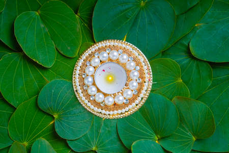 Indian festival dussehra , green leaf ,flowers and lampの写真素材