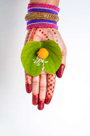 Indian festival Dussehra, green apta leaf in handの写真素材