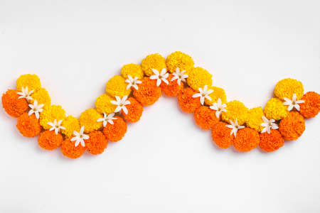Flower Rangoli for Diwali Festival made using Marigold and leaf and Oil Lamp over white background,の写真素材