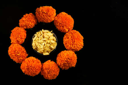 Diwali Rangoli or design made using Indian snacks , lamp and flowersの写真素材