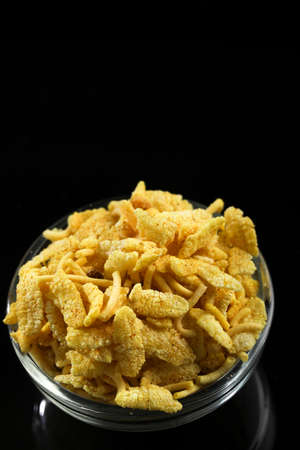 Indian snacks in bowl on dark backgroundの写真素材