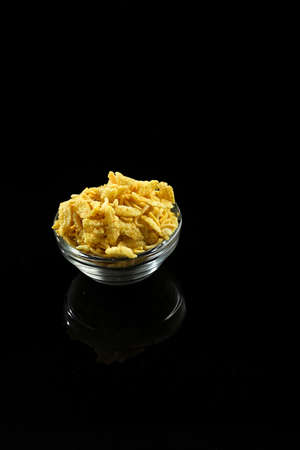Indian snacks in bowl on dark backgroundの写真素材