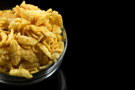 Indian snacks in bowl on dark backgroundの写真素材