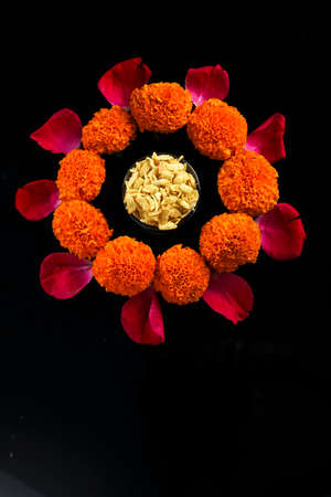 Diwali Rangoli or design made using Indian snacks , lamp and flowersの写真素材